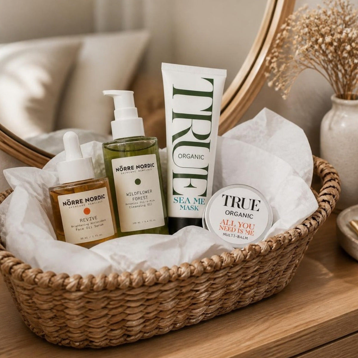 The Nordic Gift Set — REVIVE serum, Wildflower cleanser, Sea Me Mask and Multi-Balm naturally arranged in a wicker basket